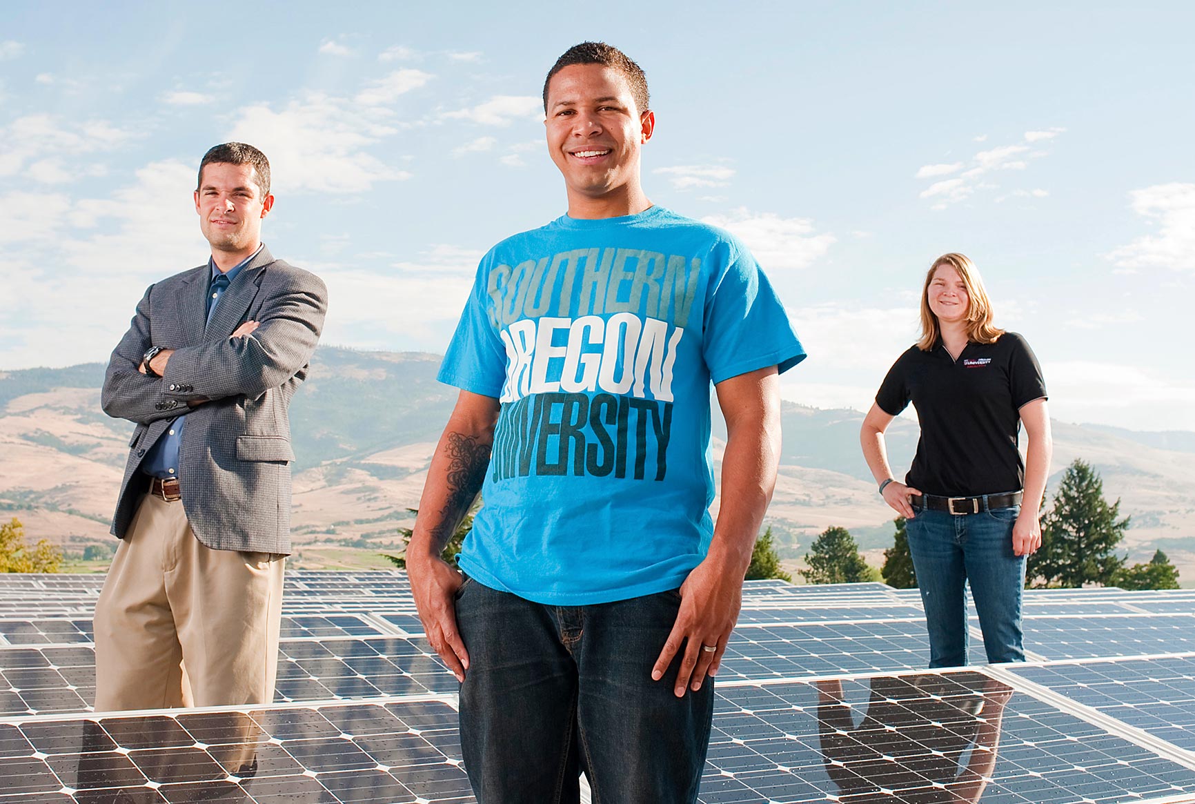 Professors and students standing in front of new solar panels