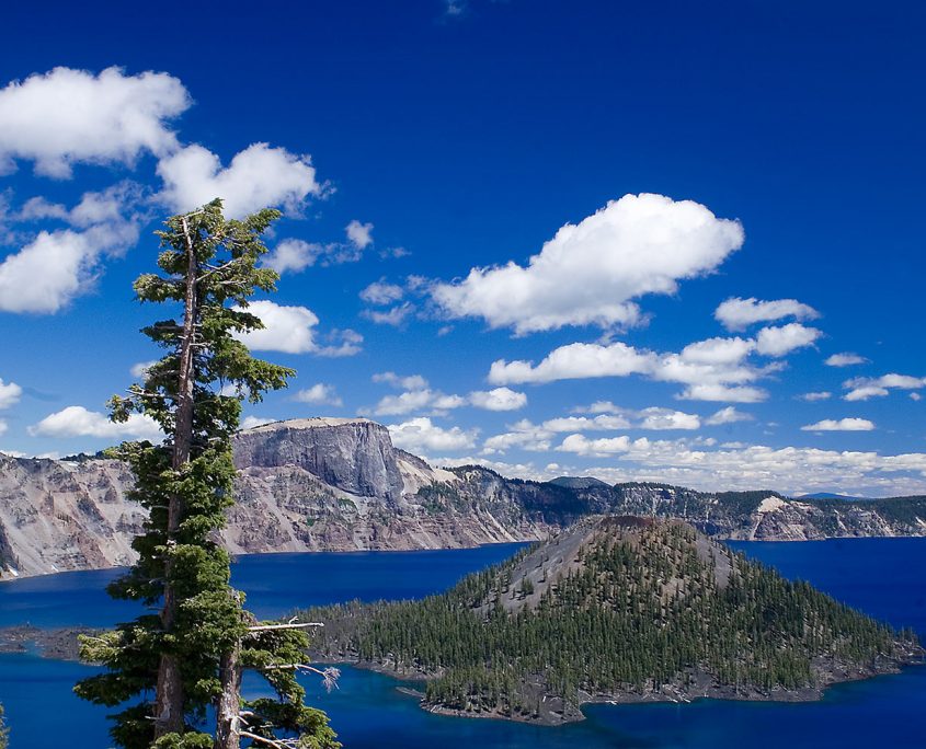 Bright blue sky with clouds over Crater Lake - Wizard Island
