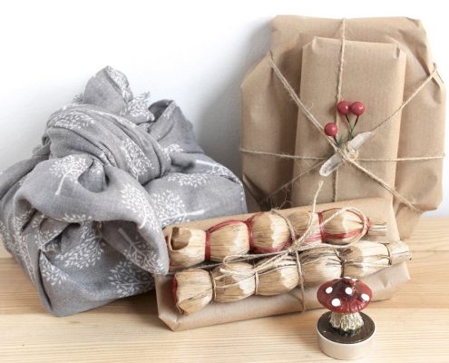gifts wrapped with zero waste items such as a scarf and scrap paper